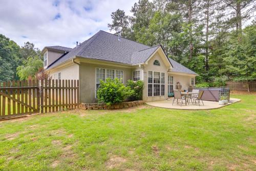 a small house with a wooden fence in a yard at Fayetteville Retreat with Hot Tub and Fenced Yard in Fayetteville