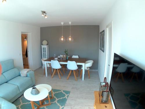 salon z niebieską kanapą i stołem w obiekcie SHERRY HOME w mieście Jerez de la Frontera