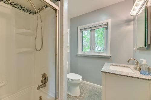 a bathroom with a shower and a toilet and a sink at Charming Canandaigua Lake House w/ Deck & Views! in Rushville