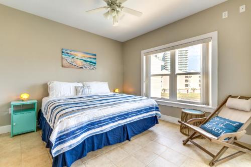 a bedroom with a bed and a chair and a window at Bayfront Pensacola Beach Condo with Pool and Elevator in Pensacola Beach