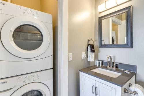 a bathroom with a washing machine and a sink at Bayfront Pensacola Beach Condo with Pool and Elevator in Pensacola Beach