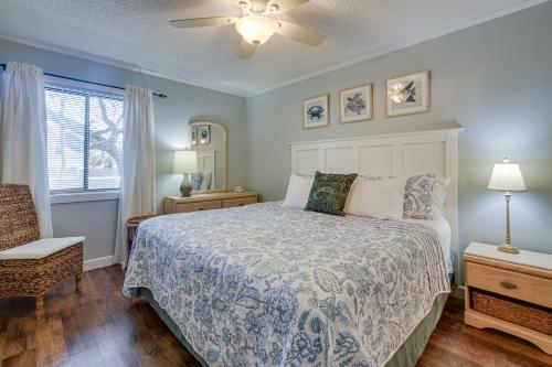 a bedroom with a bed and a chair and a window at Serene Myrtle Beach Condo with Resort Amenities! in Myrtle Beach