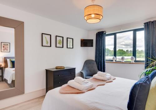 a bedroom with a bed with towels on it at The Grainstore in Briston