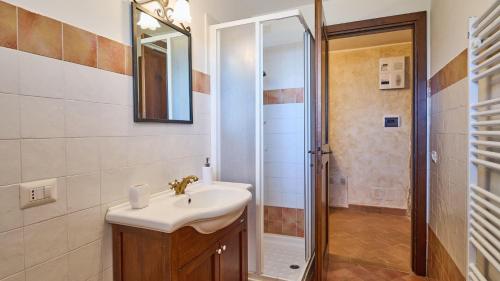 a bathroom with a sink and a shower at Casale Conte Jacopo 10 in Magione