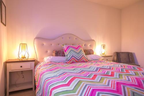 a bedroom with a large bed with a colorful bedspread at Irvine Spectrum/2 Bedrooms/2 Bathrooms/Apartment/pool/gym in Irvine