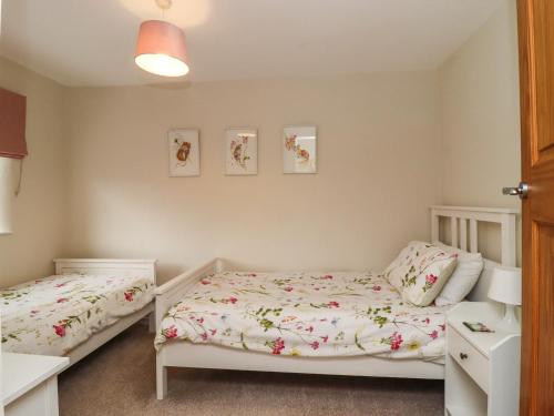 a bedroom with two twin beds in it at 1 The Old Chapel in Otley