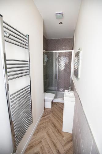 a bathroom with a shower and a toilet at Church Street Apartments in Hartlepool