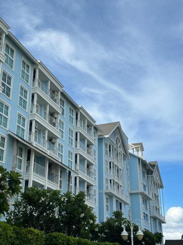 a large apartment building with blue and white at Grand Florida BeachFront Resort NaJomtien Pattaya in Na Jomtien