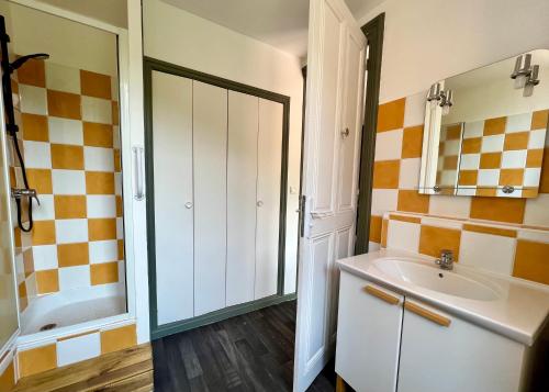 a bathroom with a sink and a shower at Appart'hôtel Les Célestins in Vals-les-Bains