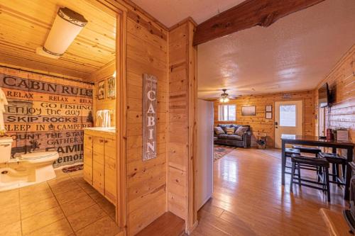 a dining room and living room in a log cabin at Cabin #6 Bobcat Bunkhouse - Pet Friendly - King Bed - Sleeps 4 in Payson