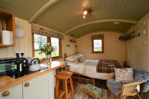 a kitchen with a bed in a small room at The Shepherds Hut in Carmarthen