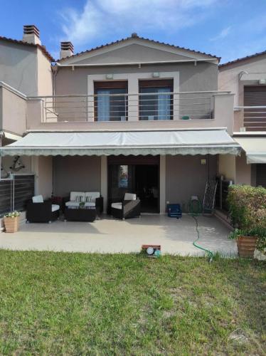 a house with an awning on a patio at Villa La Bella Vista in Skála Foúrkas