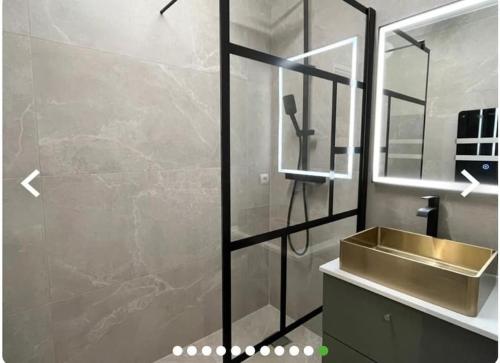 a bathroom with a sink and a glass shower at beautiful apartment design next to the sea in Antibes