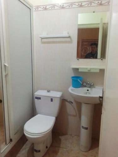 a bathroom with a toilet and a sink at Apartments in Attaouia Wonderful in Attaouiya ech Chaïbiya