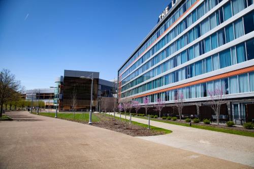a large office building with trees in front of it at The Landing Hotel at Rivers Casino Pittsburgh in Pittsburgh