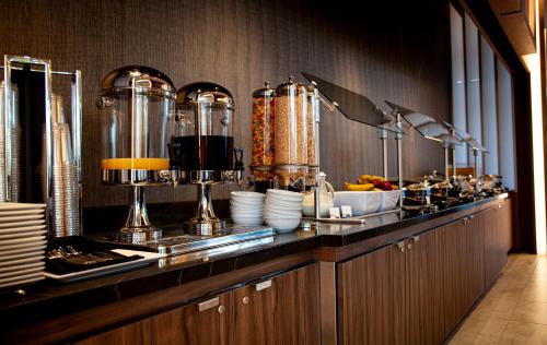 a kitchen with a counter with plates at The Landing Hotel at Rivers Casino Pittsburgh in Pittsburgh