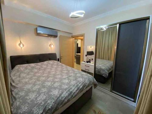 a bedroom with a bed and a mirror at Center apartment in Fethiye