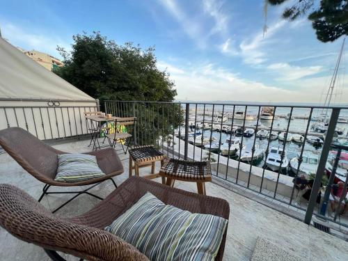 a balcony with chairs and a view of a marina at V&T Apartment in Brela