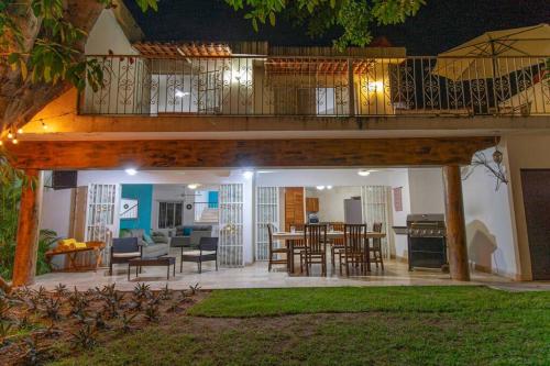 a living room and dining room with a large deck at Casa Ines Alberca Privada in Puerto Vallarta