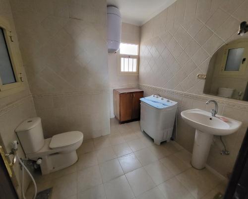 a bathroom with a toilet and a sink at Lake & Sea View Duplex in Marina 2 in El Alamein