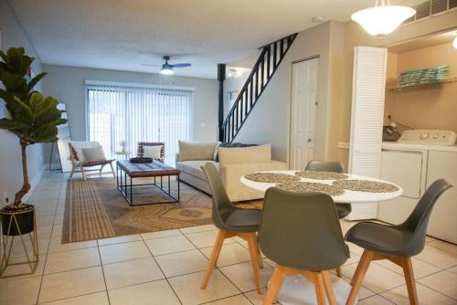 a living room with a table and chairs and a couch at USF & Busch Gardens Townhome Stay in Tampa
