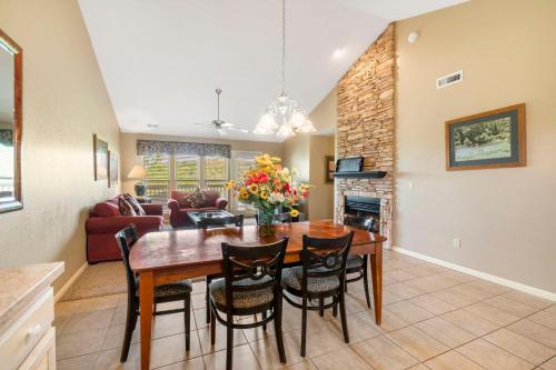 a dining room and living room with a table and chairs at StoneBridge Village Resort in Reeds Spring