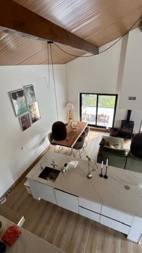a kitchen with a sink and a living room at Casa Luz in Guia