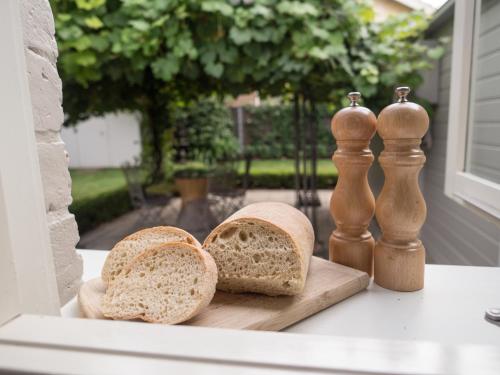 two slices of bread sitting on a cutting board at Cottage 79 in Orange