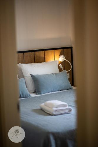 a bed with a white towel on top of it at PALMERA STUDIOS in Ofrínion