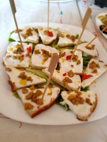 a plate of food withasted sandwiches with nuts on them at Bar-Restaurant-Hotel-Familja in Klos