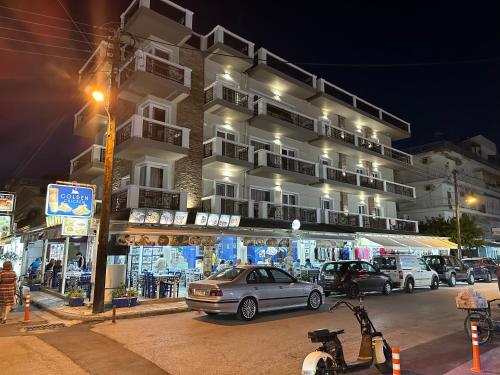 a car parked in front of a building at night at Apartments Villa Effie in Paralia Katerinis