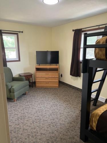 a living room with a television and a bunk bed at All Star Inn & Suites in Wisconsin Dells