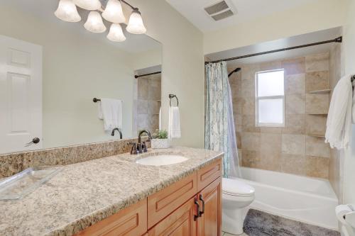 a bathroom with a sink and a tub and a toilet at Pet Friendly Pool Home in River Reach of Naples FL in Naples