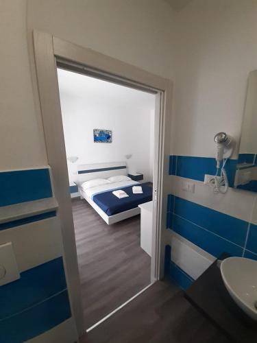 a bathroom with a door leading to a bedroom at La Llua Alghero in Alghero