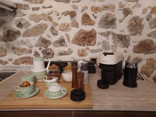 a wooden counter with various items on a counter top at Stone House - Πέτρινο Σαλέ in Alíartos