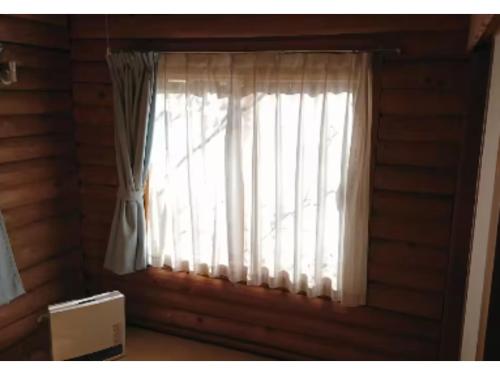 a window with white curtains in a room at Karuizawa Sunny Village - Vacation STAY 57957v in Karuizawa