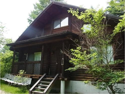 a log cabin with stairs leading up to the front door at Karuizawa Sunny Village - Vacation STAY 57957v in Karuizawa