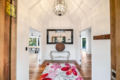 a living room with a bench and a mirror at Ninderry Manor-Spectacular Hinterland retreat in Ninderry