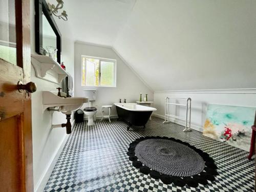 ein Badezimmer mit einem Waschbecken, einer Badewanne und einem WC in der Unterkunft Tranquility in Hermanus