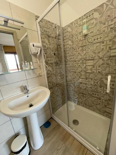 a bathroom with a sink and a shower at Ce sta 'o mar for in Naples