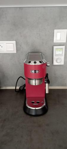 a red coffee maker sitting on top of a counter at Apartmány Aktiv Lipno in Lipno nad Vltavou