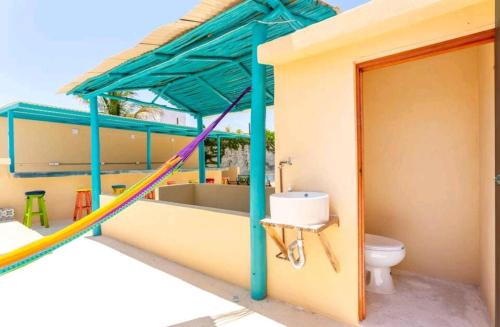 a bathroom with a sink and a toilet on a building at Numa Hotel Boutique in Playa del Carmen