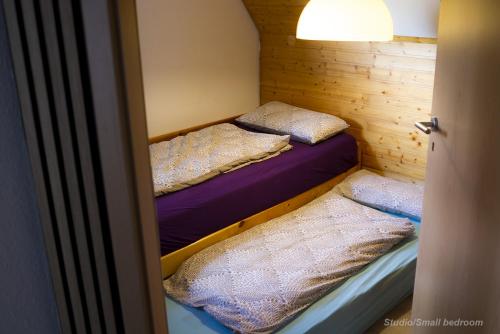 two bunk beds in a small room with a door at 71 square meters Condo in Schwarzwald with beautiful mountain view, free wifi in Schonwald im Schwarzwald