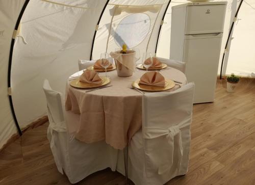 a table in a tent with hats on it at Villa Malibu ' in Lauria