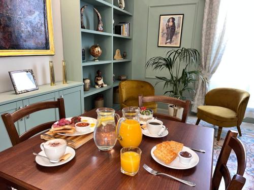 a dining room table with breakfast foods and orange juice at Ta' Dun Martin and taz-Zija Bed and Breakfast in Nadur