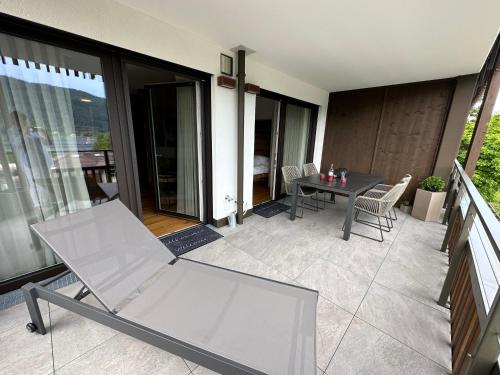 a chair and a table on a balcony at Apartment Deluxe Ossiacher See - Gerlitzen in Sattendorf