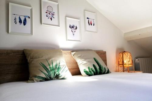 Un dormitorio con una cama con plantas en las almohadas en Le Petit Moselle- métro Mermoz-Parc Parilly, en Bron