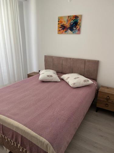 a bedroom with a bed with two pillows on it at Silver house in Dalaman