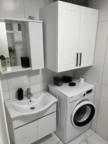 a white bathroom with a washing machine and a sink at Silver house in Dalaman