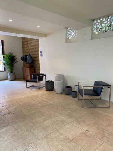 a living room with two chairs and a table at Alko Hotel Casa Nispero in Cali
